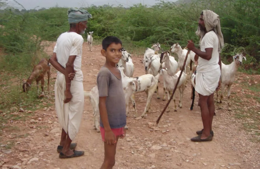 Volunteer helping distribute school supplies in a rural area