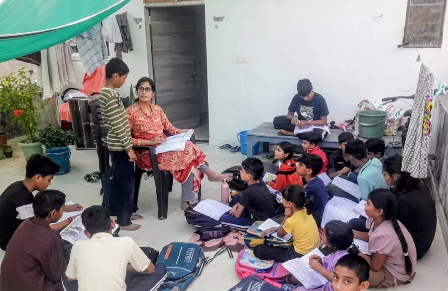 School children engaged in group learning session outside