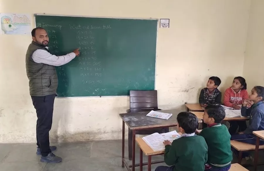 Small group reading session with volunteer and village children