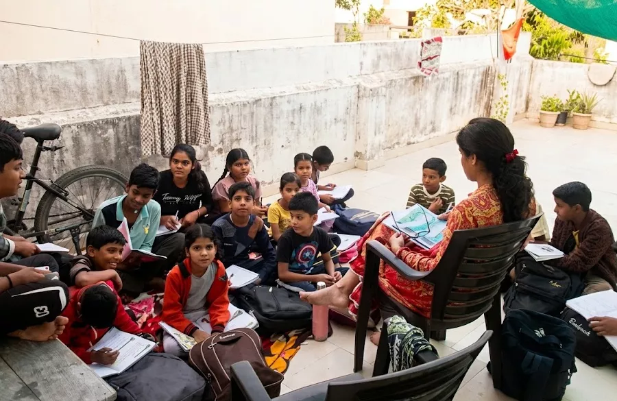 Students learning together under tree shade at school campus